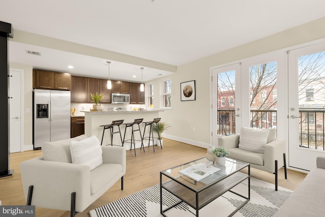 living room with light hardwood / wood-style floors