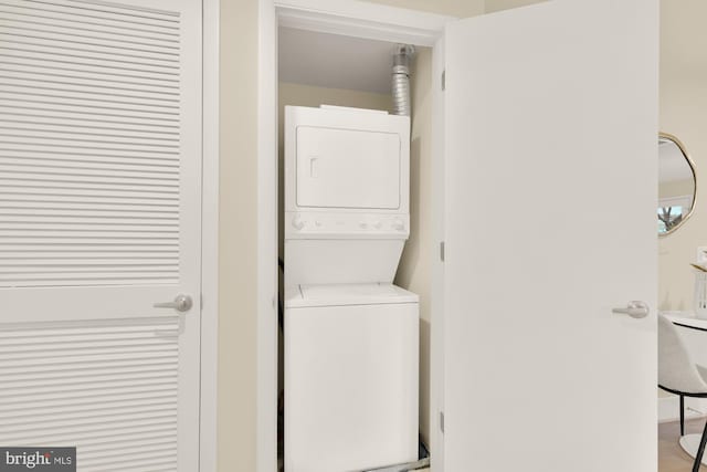 laundry area with stacked washer / drying machine