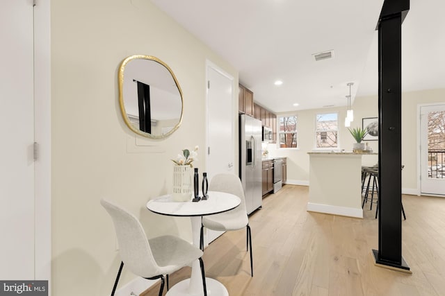 dining space with light hardwood / wood-style floors