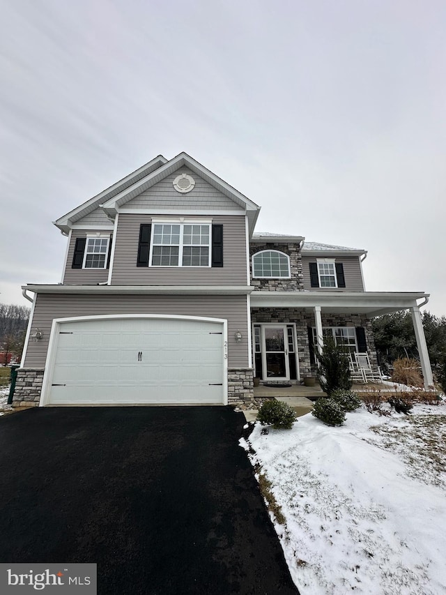 front of property with a porch and a garage