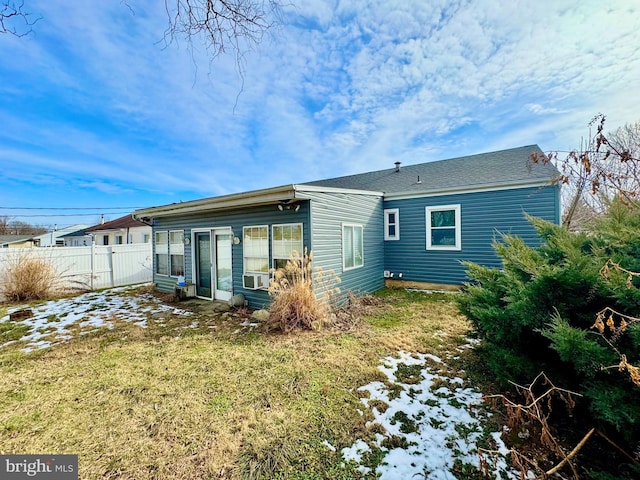 rear view of property featuring a yard