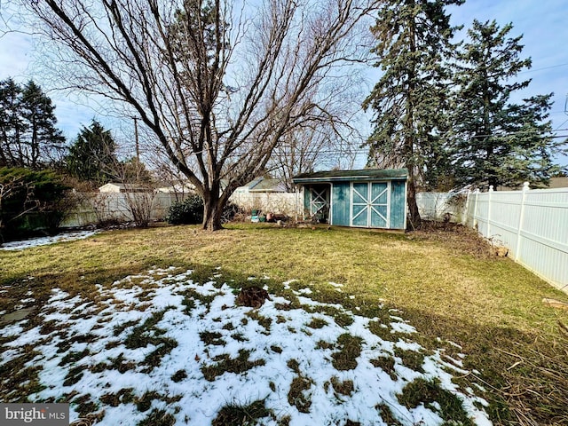 yard layered in snow featuring a storage unit