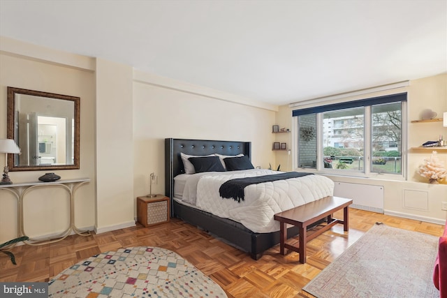 bedroom with parquet floors and radiator