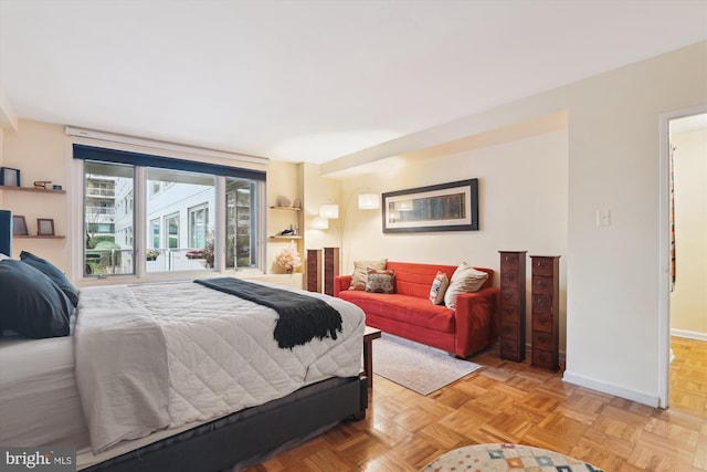 bedroom with light parquet flooring