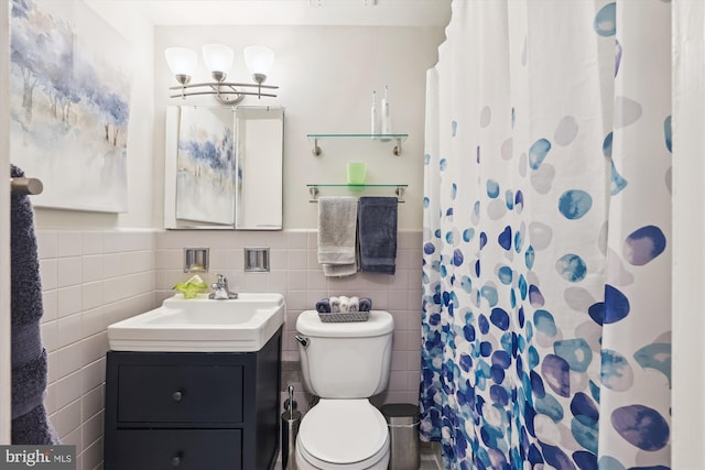 bathroom featuring vanity, curtained shower, tile walls, and toilet