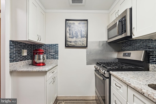 kitchen with appliances with stainless steel finishes, light stone countertops, and white cabinets