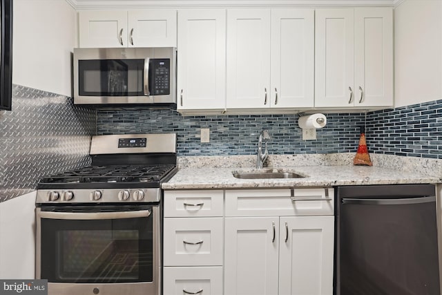 kitchen with sink, stainless steel appliances, and white cabinets