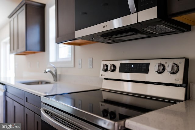 kitchen with appliances with stainless steel finishes, gray cabinets, and sink