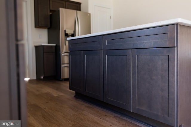 kitchen featuring stainless steel refrigerator with ice dispenser and dark hardwood / wood-style floors