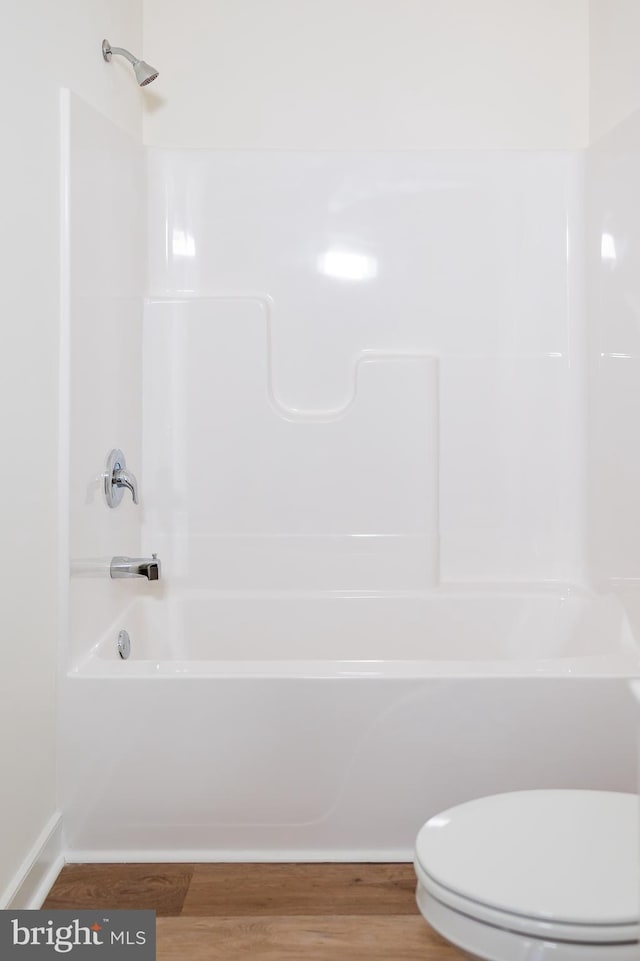 bathroom featuring hardwood / wood-style flooring and toilet