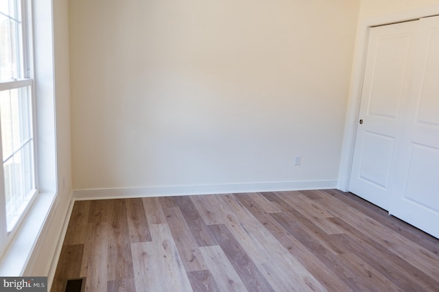 unfurnished room with light hardwood / wood-style flooring