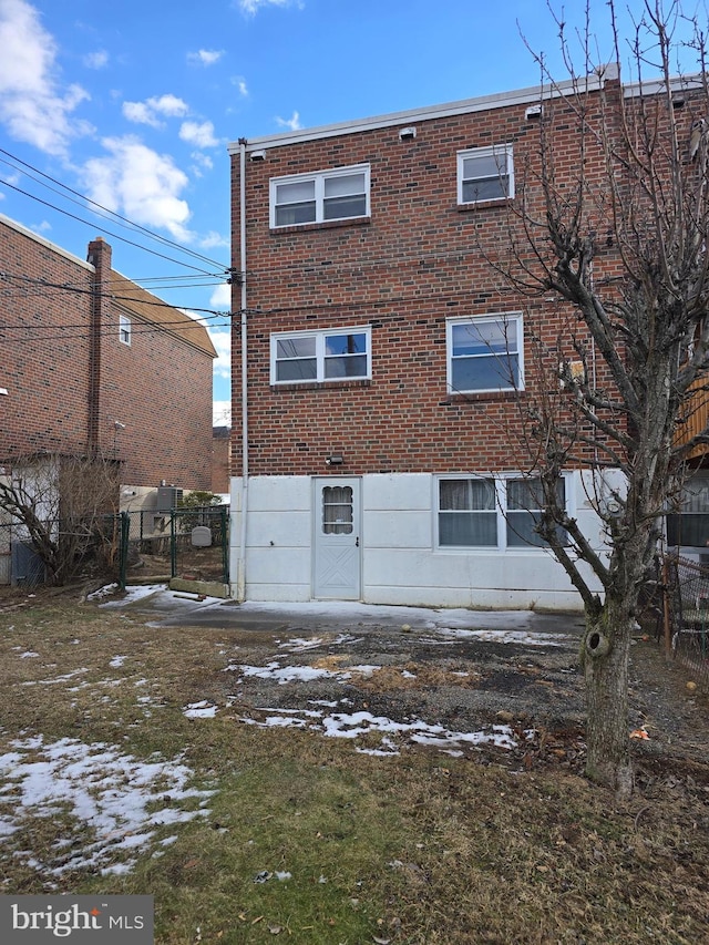 view of snow covered rear of property