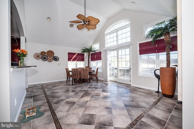 dining area featuring ceiling fan and high vaulted ceiling