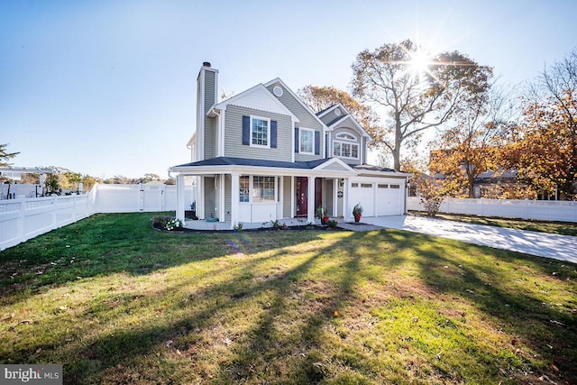 view of front facade featuring a garage, a front yard, and covered porch