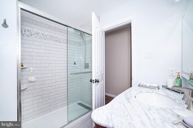 bathroom with walk in shower and vanity