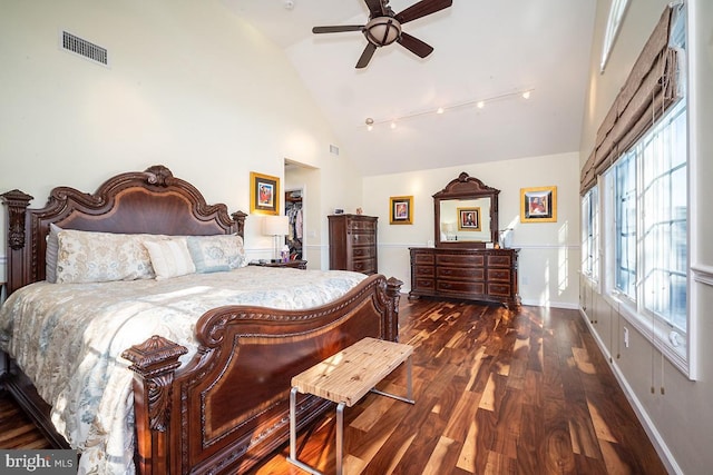 bedroom with ceiling fan, high vaulted ceiling, and dark hardwood / wood-style flooring