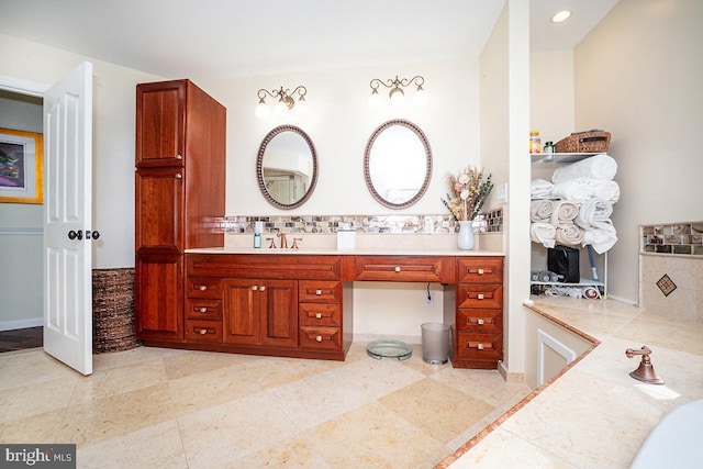 bathroom featuring vanity and backsplash