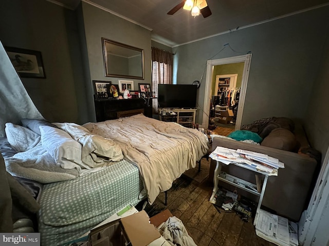 bedroom featuring ornamental molding, wood-type flooring, and ceiling fan