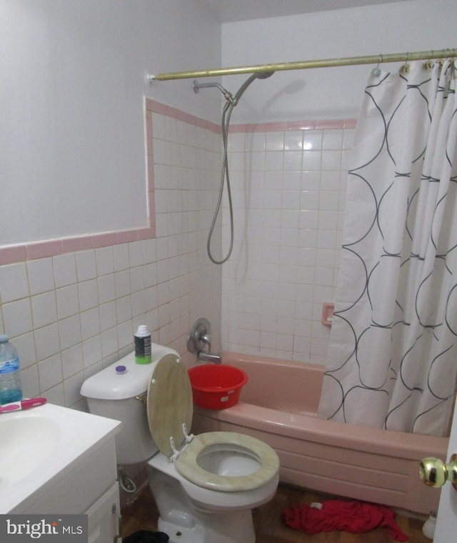 full bathroom with vanity, toilet, shower / tub combo, and tile walls