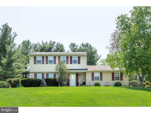 colonial home with a front lawn