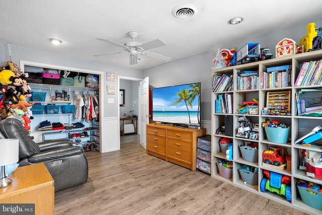 sitting room with light hardwood / wood-style flooring and ceiling fan