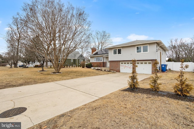 view of front of house with a garage and a front lawn