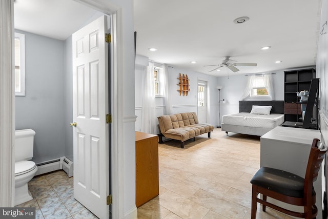 living room with ceiling fan and a baseboard heating unit