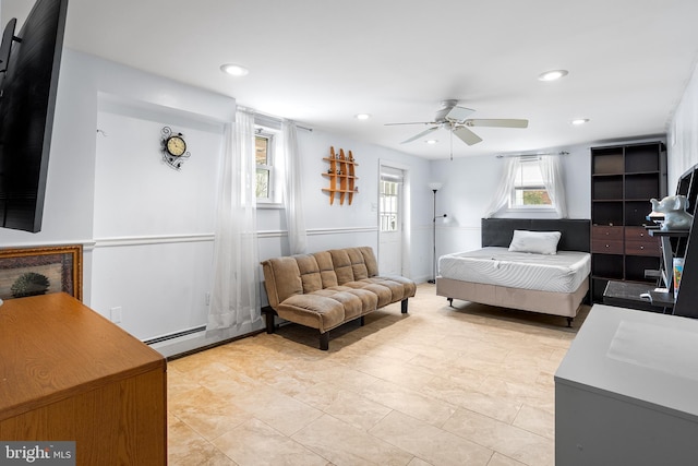 bedroom with baseboard heating and ceiling fan