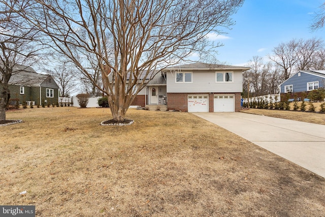 tri-level home featuring a garage and a front yard