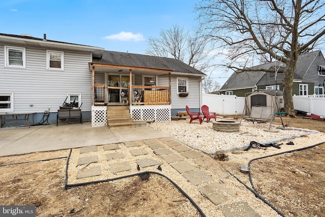 rear view of house featuring an outdoor fire pit and a patio