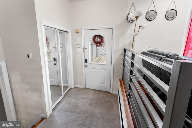 doorway with dark tile patterned floors