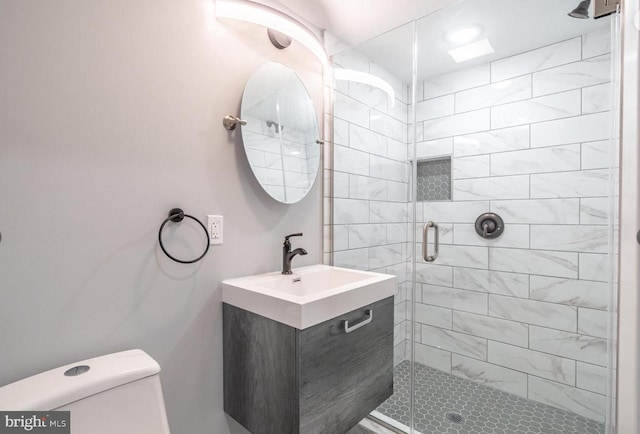 bathroom with vanity, toilet, and an enclosed shower