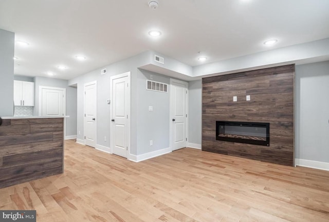 living room with a fireplace and light hardwood / wood-style floors