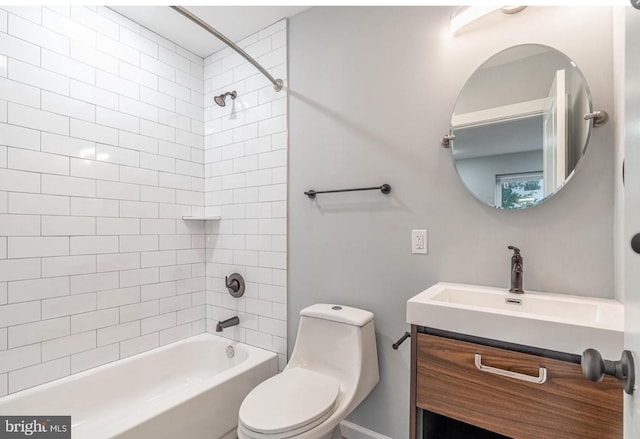 full bathroom with vanity, tiled shower / bath, and toilet