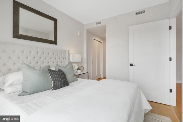 bedroom featuring a closet and light wood-type flooring