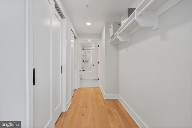 corridor with hardwood / wood-style flooring