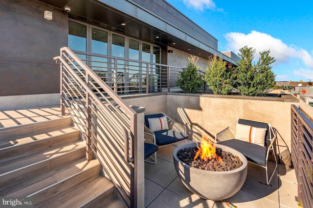 view of patio with a fire pit