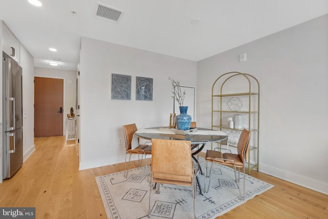 dining area with light hardwood / wood-style flooring