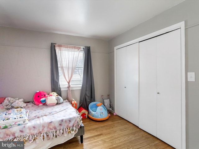 bedroom featuring light hardwood / wood-style flooring and a closet