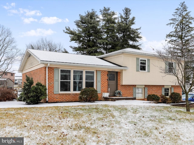 tri-level home with a front yard