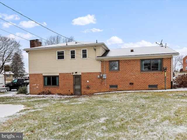 rear view of house featuring a lawn