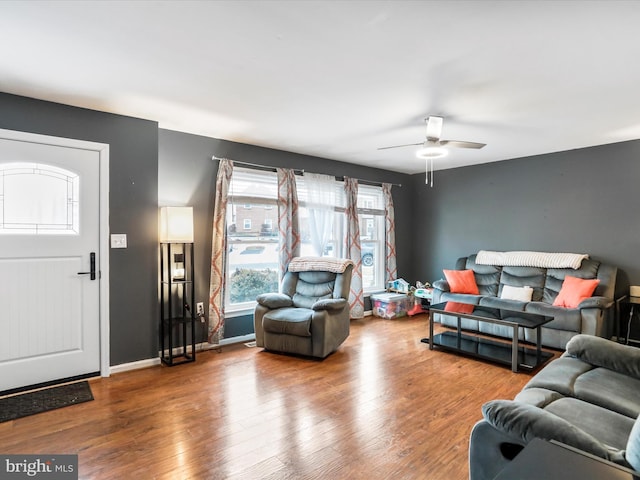 living room with hardwood / wood-style flooring and ceiling fan