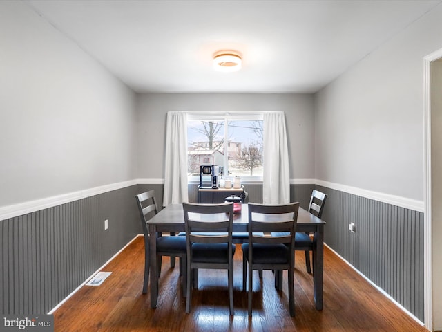 dining area featuring dark wood-type flooring