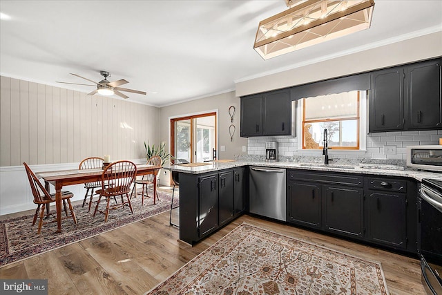 kitchen featuring stainless steel appliances, sink, a wealth of natural light, and kitchen peninsula