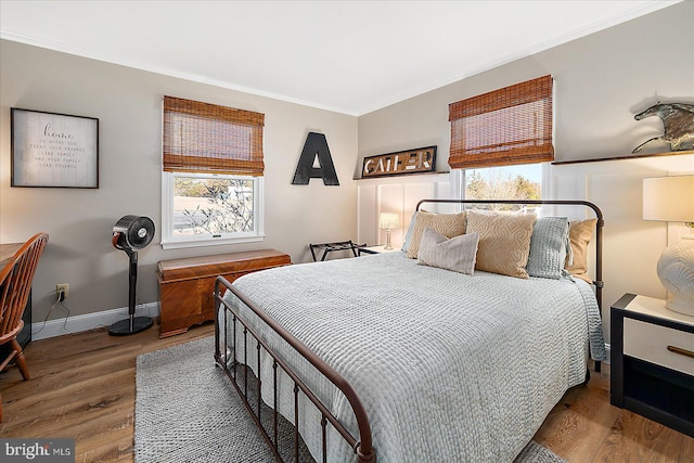 bedroom with hardwood / wood-style flooring and ornamental molding