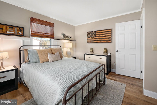 bedroom featuring dark wood-type flooring and ornamental molding