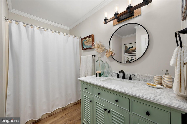 bathroom with ornamental molding, hardwood / wood-style floors, and vanity