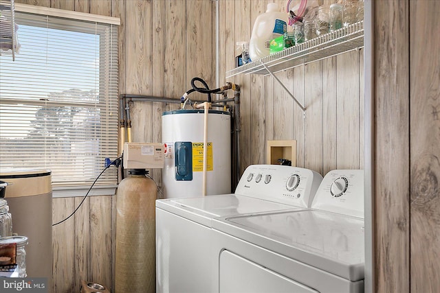 laundry room with washer and dryer and electric water heater