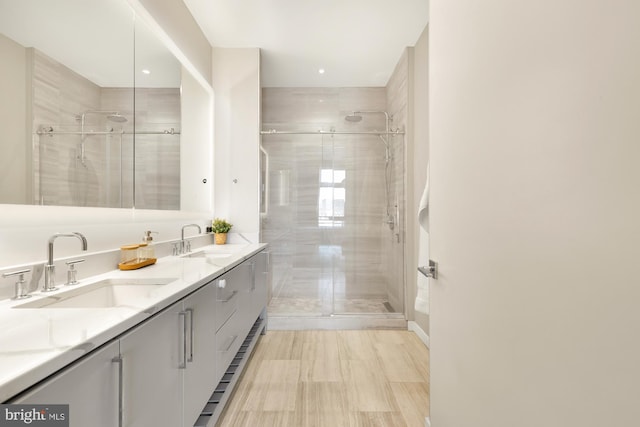 bathroom with vanity and a shower with door