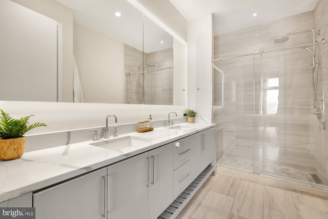 bathroom with vanity and a shower with shower door